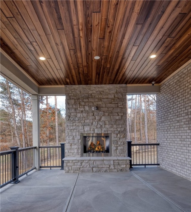 view of patio featuring an outdoor stone fireplace