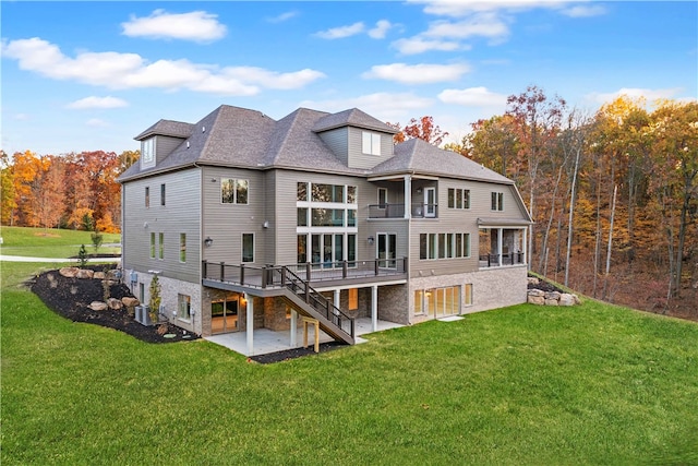 rear view of property with a patio, a deck, central AC unit, and a lawn