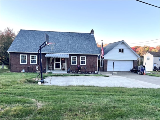 view of front of house featuring a front yard, a garage, and an outdoor structure