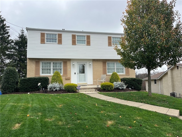 view of front of property featuring a front lawn and central AC unit