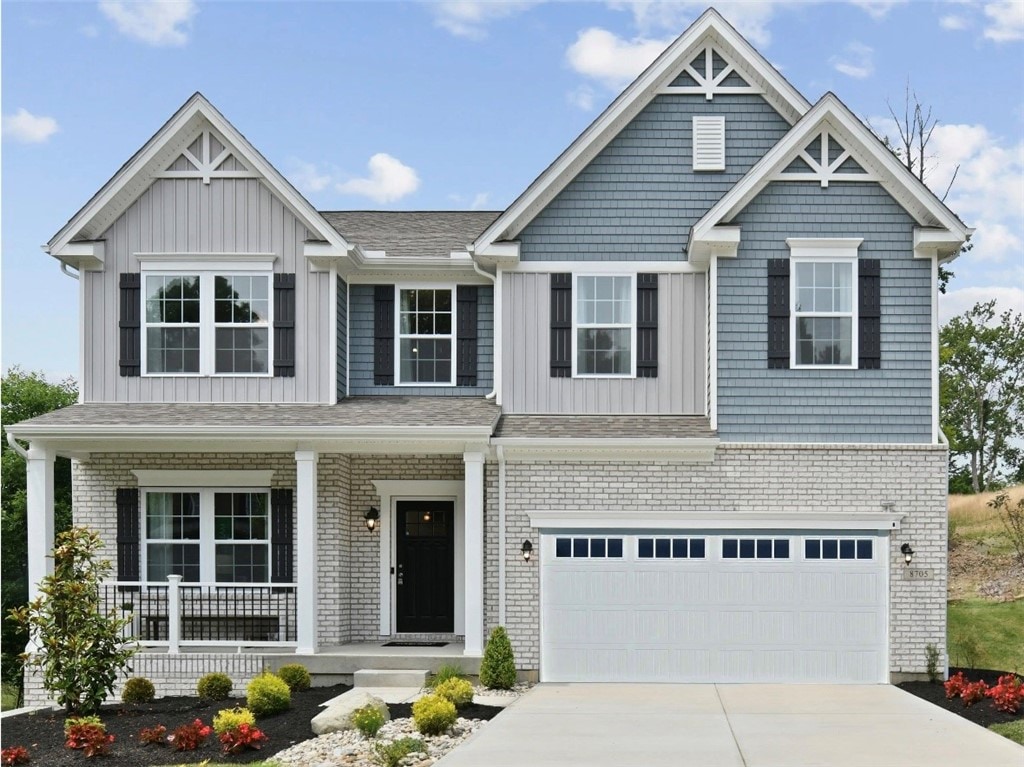 craftsman house featuring covered porch and a garage