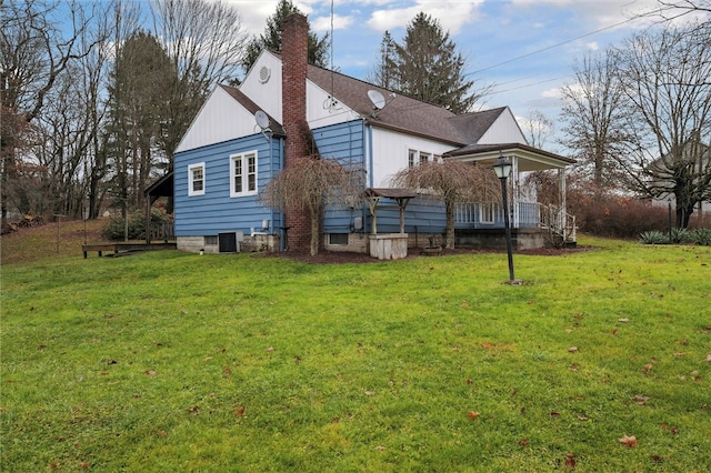 back of house with a yard and central air condition unit