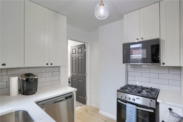 1402 Bingham St, South Side, PA 15203 - kitchen featuring stainless steel appliances, white cabinetry, and tasteful backsplash