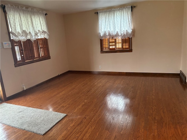 empty room with hardwood / wood-style floors