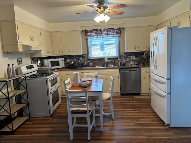 kitchen with white appliances, ceiling fan, dark wood-type flooring, sink, and cream cabinetry