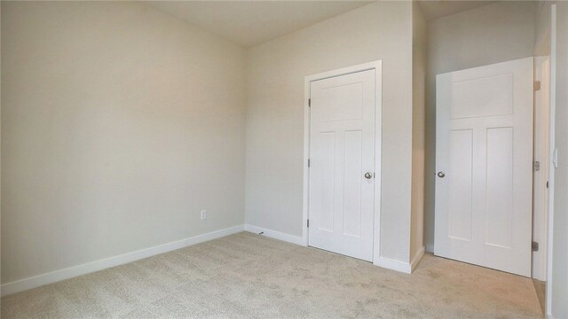 unfurnished bedroom featuring light colored carpet