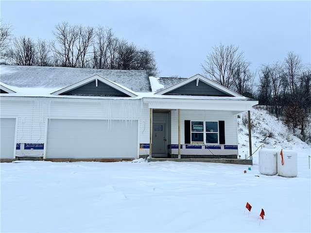 single story home with a porch and a garage