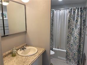 full bathroom with shower / tub combo with curtain, vanity, and toilet