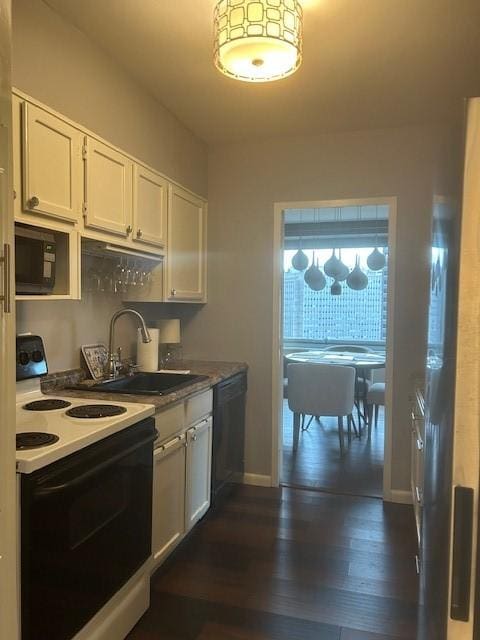 kitchen featuring dark wood-style flooring, white cabinetry, a sink, and black appliances