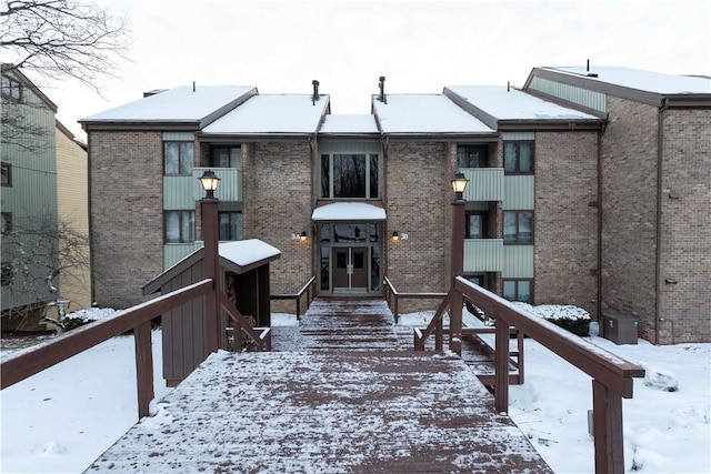 view of snow covered back of property