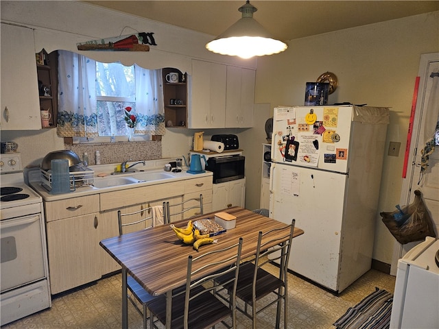 kitchen featuring white appliances and sink