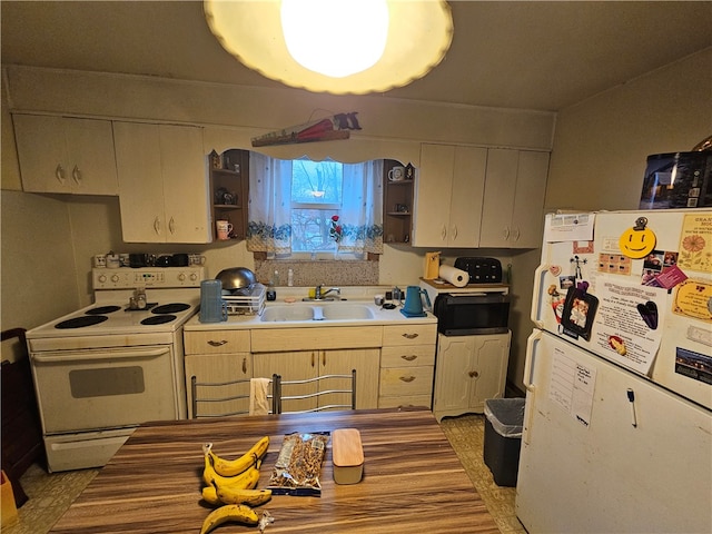 kitchen featuring white appliances and sink