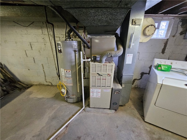 utility room with water heater and washer / dryer