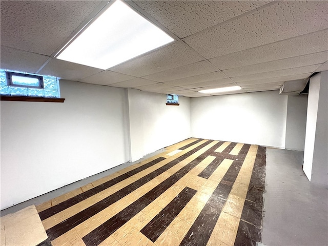 basement featuring a paneled ceiling