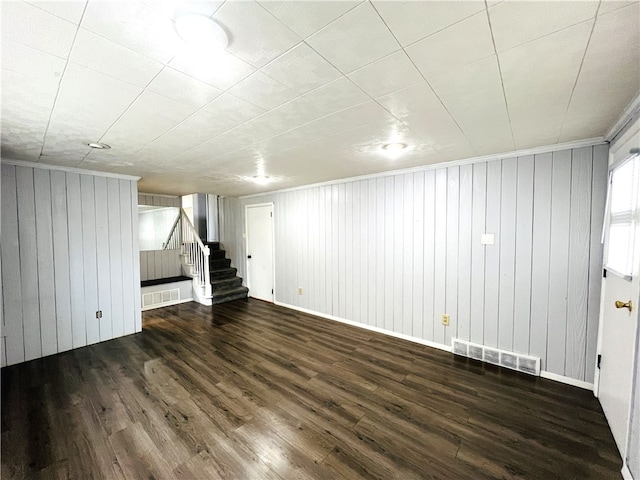 basement featuring wood walls and dark hardwood / wood-style floors