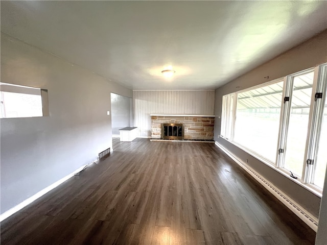 unfurnished living room with dark hardwood / wood-style flooring and a fireplace