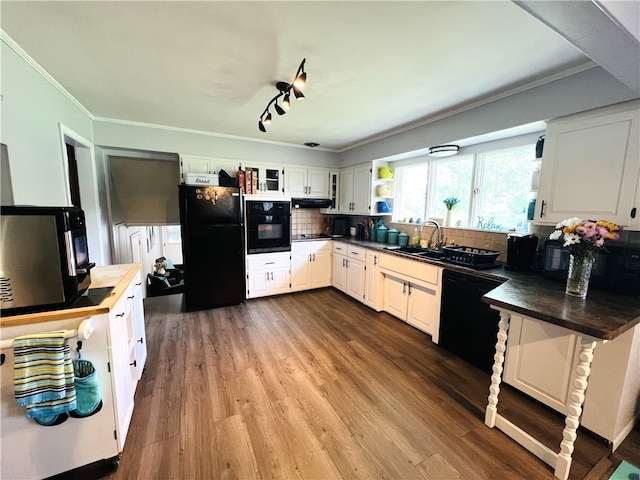 kitchen featuring black appliances, crown molding, sink, tasteful backsplash, and white cabinetry