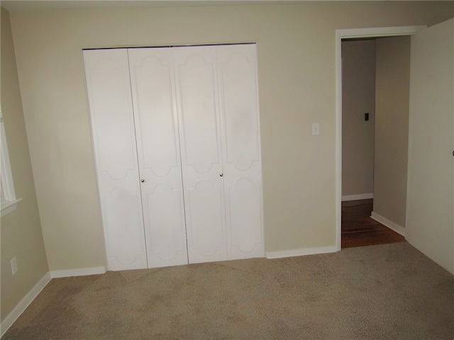 unfurnished bedroom with a closet and carpet