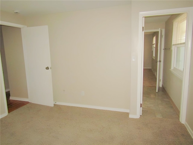 spare room with light colored carpet