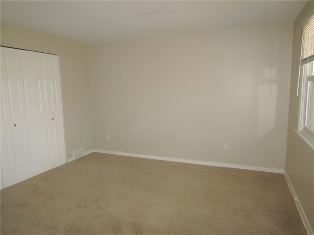 unfurnished bedroom with a closet and carpet floors