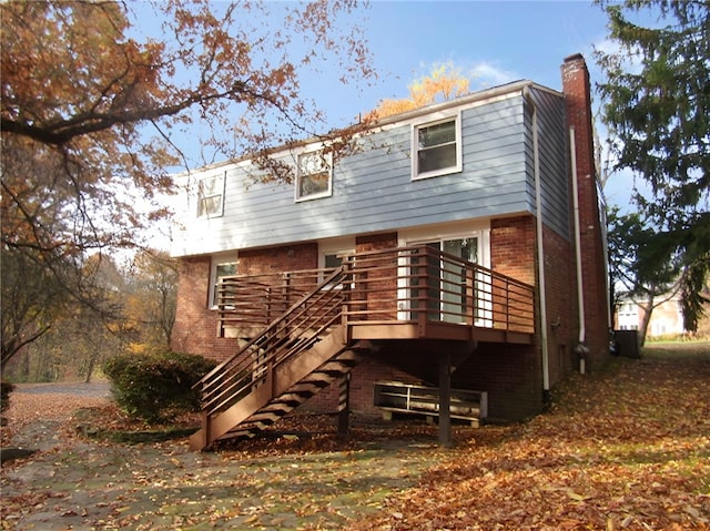 back of property featuring a deck