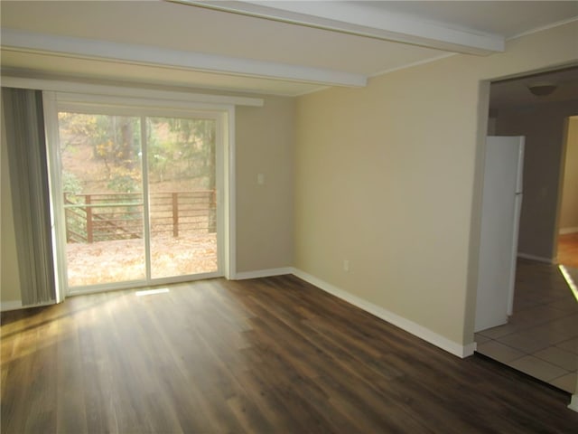 spare room featuring beamed ceiling and dark wood-type flooring