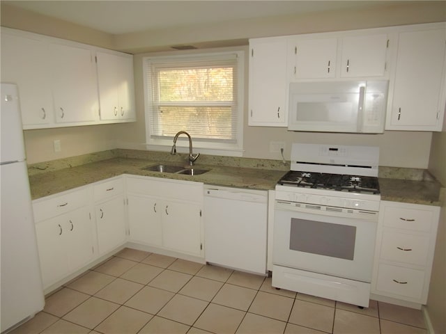 kitchen featuring light tile patterned floors, white appliances, white cabinetry, and sink