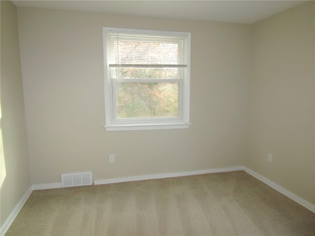 empty room featuring light colored carpet