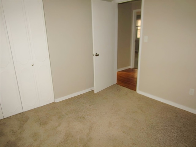 unfurnished bedroom with carpet floors and a closet