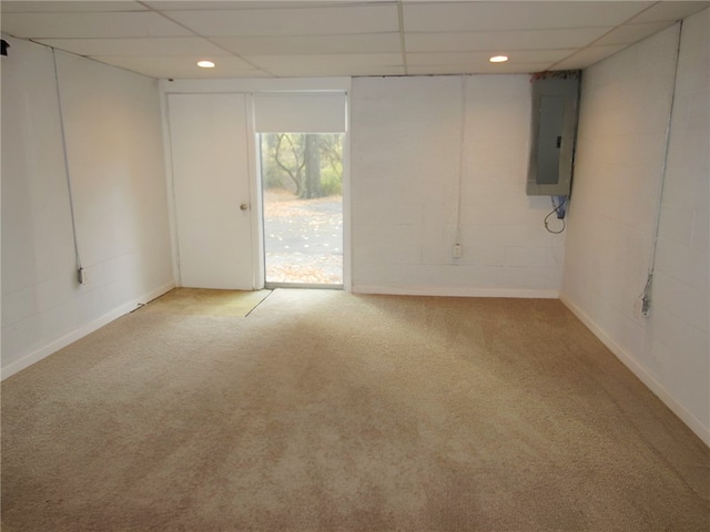 spare room with carpet, a paneled ceiling, and electric panel