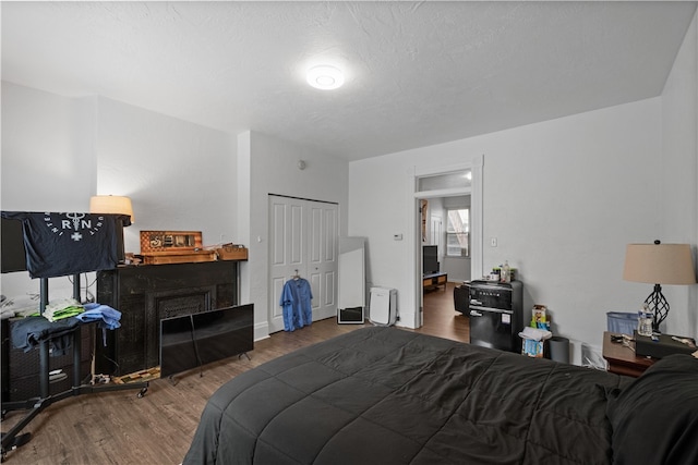 bedroom featuring a textured ceiling, hardwood / wood-style flooring, and a closet