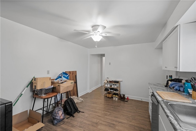 interior space with ceiling fan, dishwasher, sink, dark hardwood / wood-style floors, and white cabinets