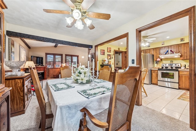 dining room with ceiling fan, light tile patterned floors, and vaulted ceiling