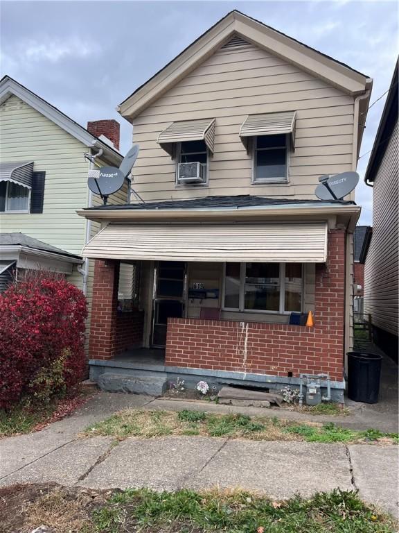 619 9th St, Glassport, PA 15045 - view of front of property featuring brick siding, a porch, and cooling unit