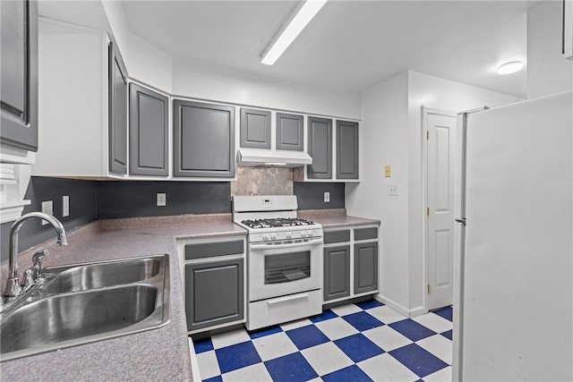 kitchen with sink, tasteful backsplash, range hood, white appliances, and gray cabinets