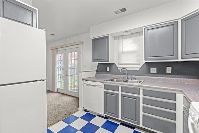 kitchen featuring light carpet, french doors, white appliances, sink, and gray cabinets