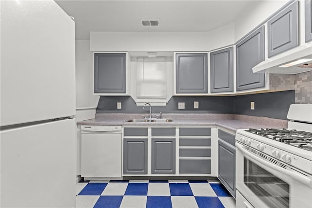 kitchen featuring white appliances, gray cabinets, wall chimney exhaust hood, and sink