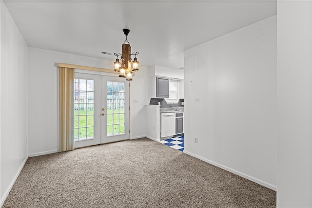 interior space with sink, french doors, dark carpet, and an inviting chandelier