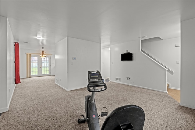 workout room with light carpet and french doors