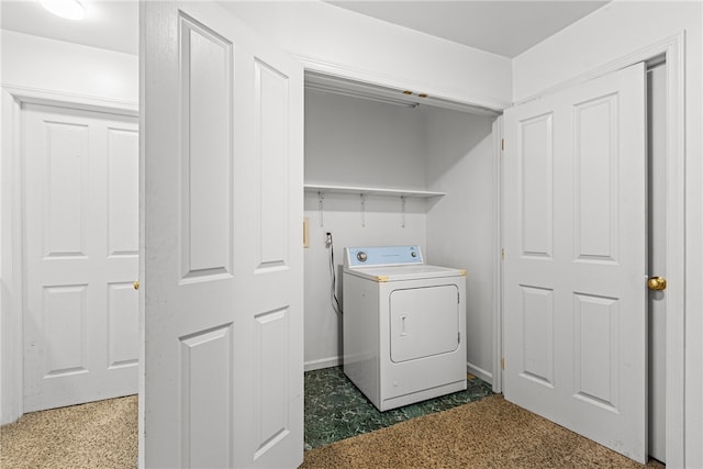 clothes washing area with washer / dryer and dark carpet