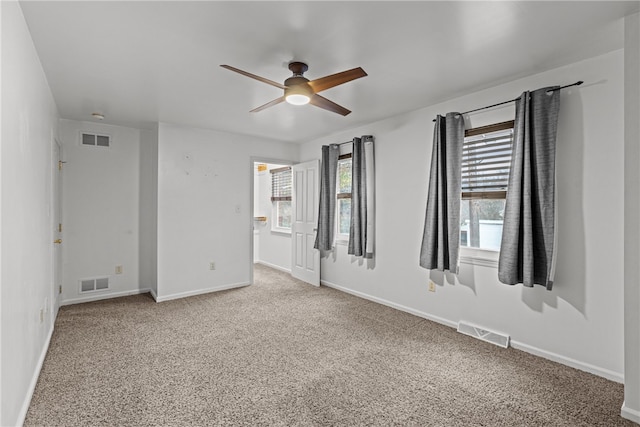 spare room featuring ceiling fan and carpet