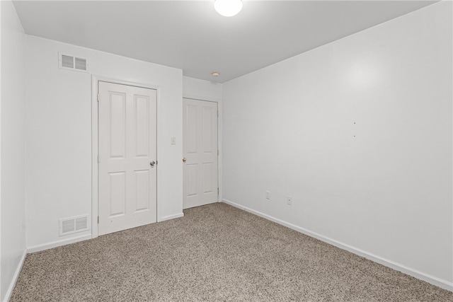 unfurnished bedroom featuring carpet floors and a closet