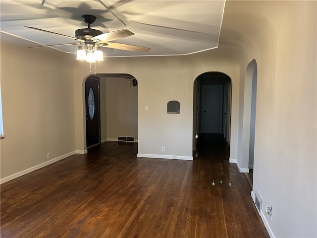 unfurnished room with dark hardwood / wood-style floors and ceiling fan