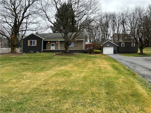 single story home featuring an outbuilding, a front yard, and a garage