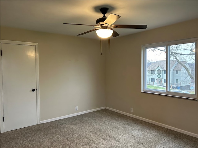 carpeted empty room with ceiling fan