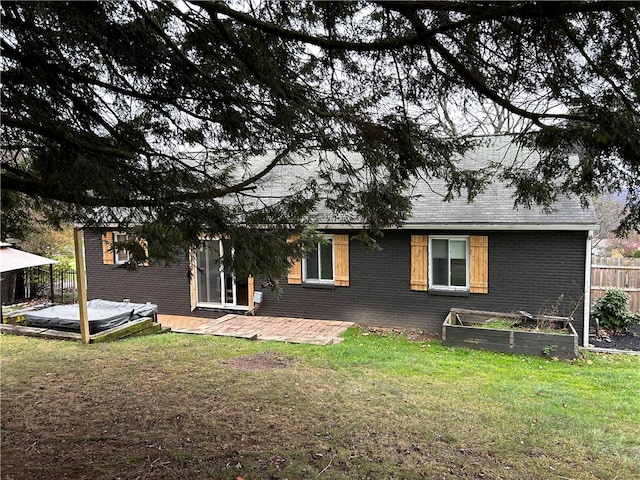 rear view of property featuring a yard and a deck