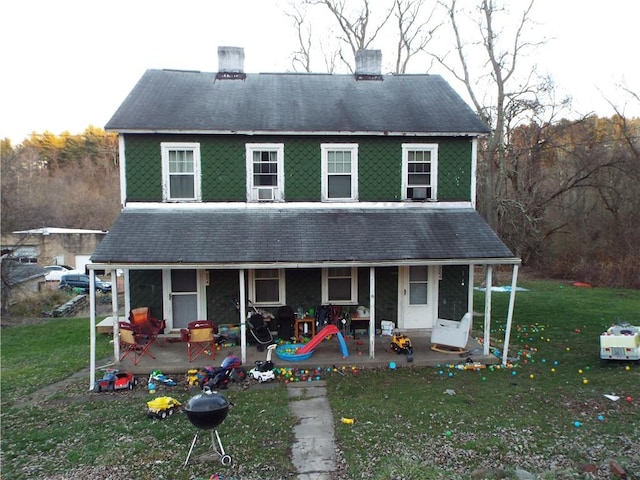 204 Tower Rd, Luzerne Twp, PA 15428 - rear view of house featuring a chimney, a lawn, and a patio