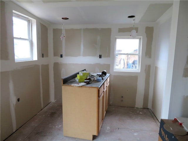 kitchen with decorative light fixtures, a healthy amount of sunlight, and light brown cabinets