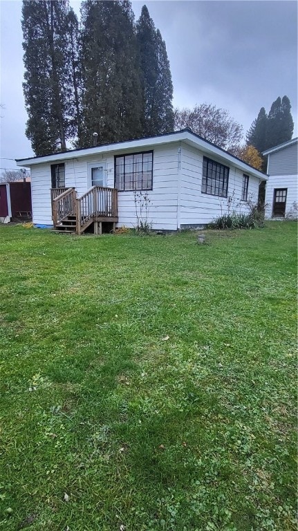 rear view of house with a lawn