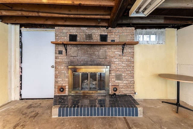 interior details with a fireplace and concrete floors